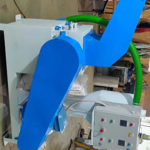 Blue and light-grey cutting machine with a control panel and green hose.