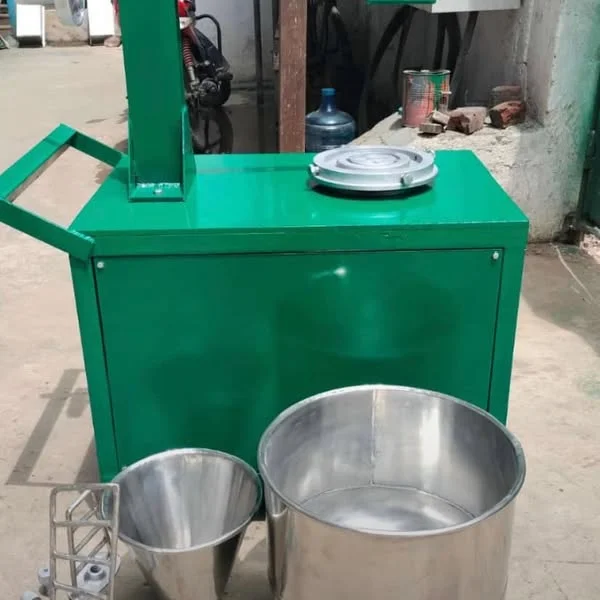 Ink mixing equipment with metal mixing vessels in the workshop.