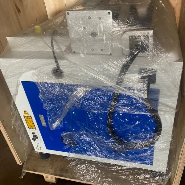 Blue and white laser printing equipment packaged in the workshop.